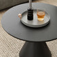 Moderne zwart/witte salontafel met ronde bovenkant, ijzeren voetstuk, cocktailtafel uit het midden van de eeuw
