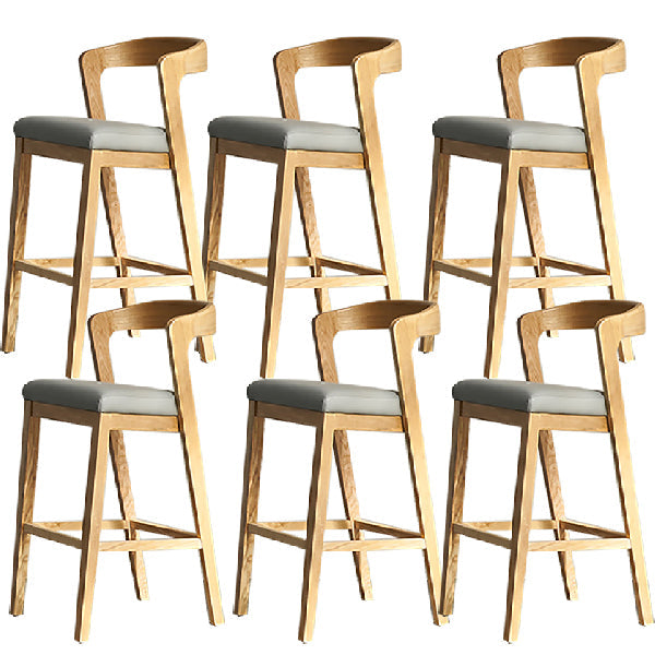 Eigentijdse houten barkruk met lage rugleuning en voetsteunkruk
