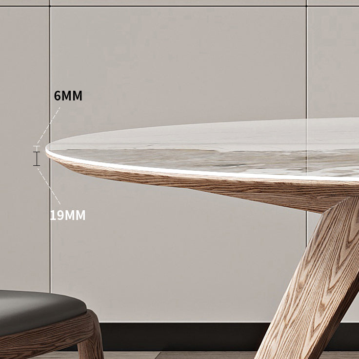 Witte gesinterde stenen tafel rond huiskeukendiner met natuurlijke poten