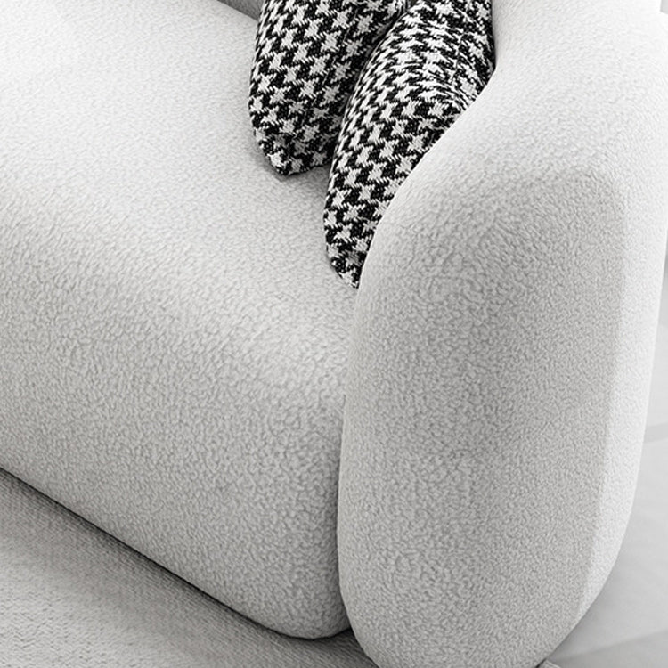 Canapé incurvé moderne dans un canapé de bras en pente en laine blanche avec oreillers