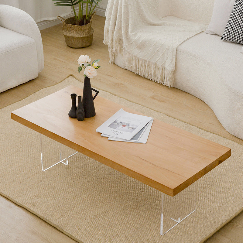 Table basse scandinave avec plateau en bois massif et base en acrylique
