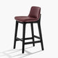Taburete de bar de cuero con respaldo para mostrador Bristol con patas de madera