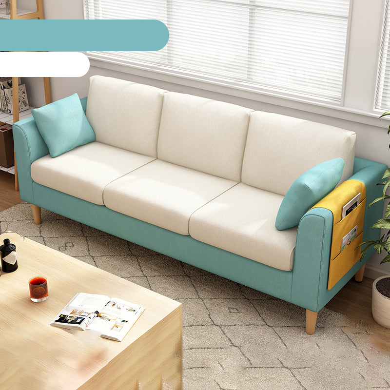 Canapé scandinave de 3 places avec oreillers en dos et bras de smoking et pattes en bois massif