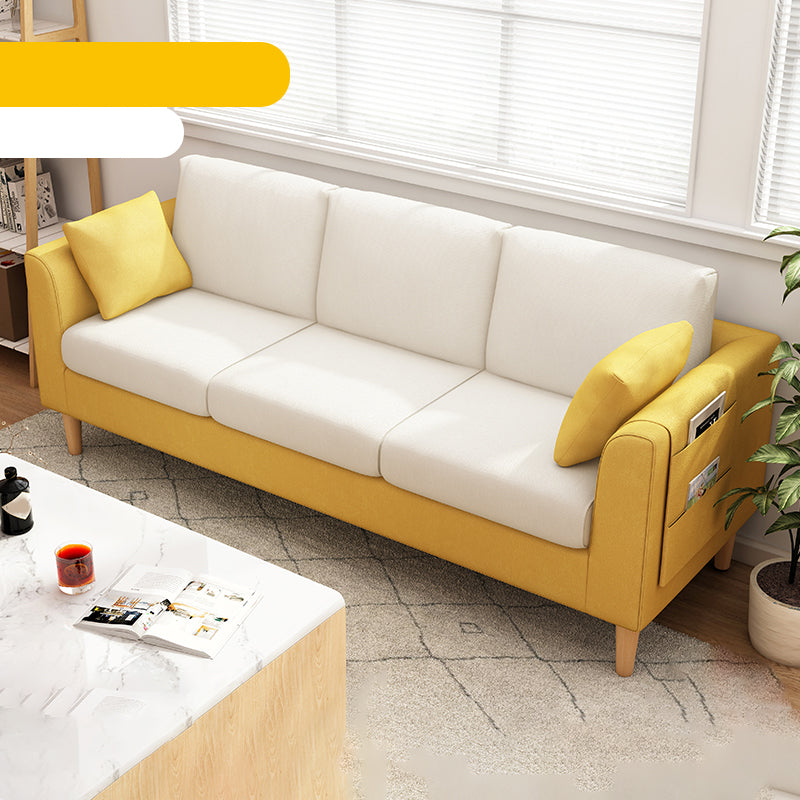 Canapé scandinave de 3 places avec oreillers en dos et bras de smoking et pattes en bois massif