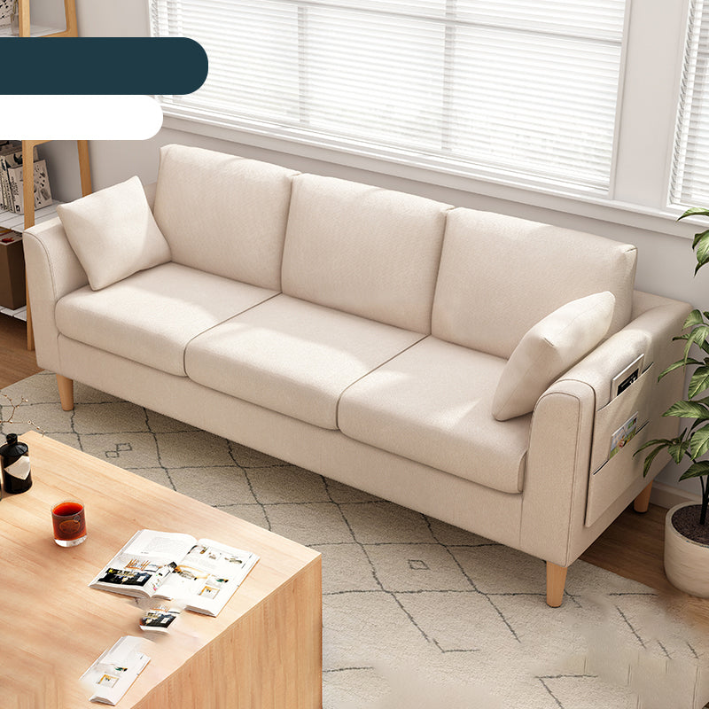 Canapé scandinave de 3 places avec oreillers en dos et bras de smoking et pattes en bois massif