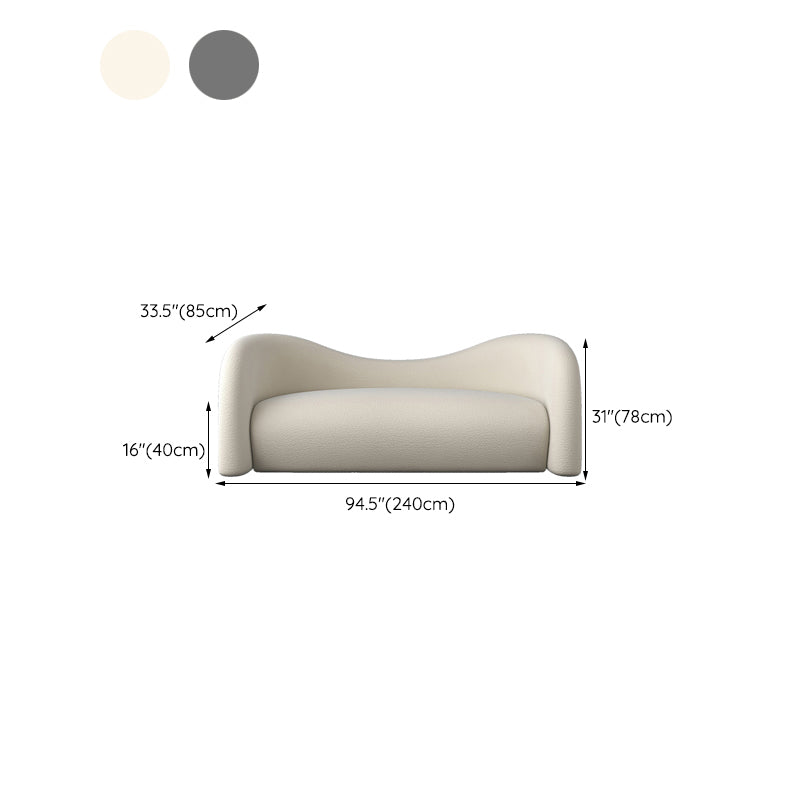 Divano beige e grigio scuro smoking a sedere con cuscini per l'appartamento