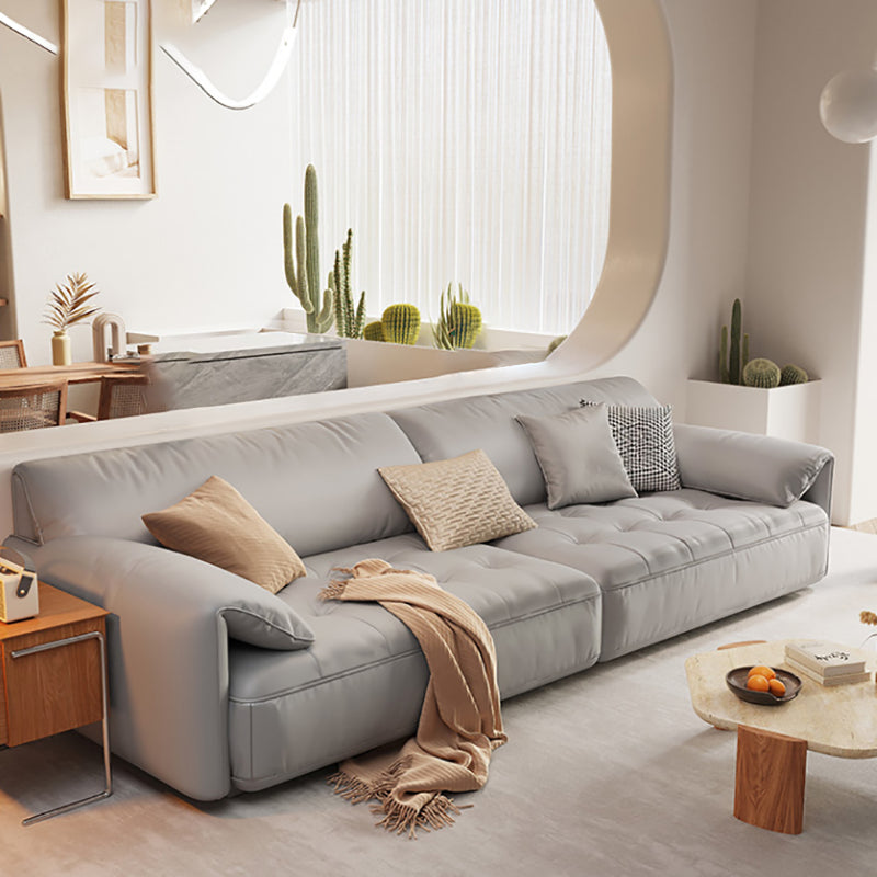 Sofá seccional con brazo superior tipo almohada en madera maciza con respaldo acolchado