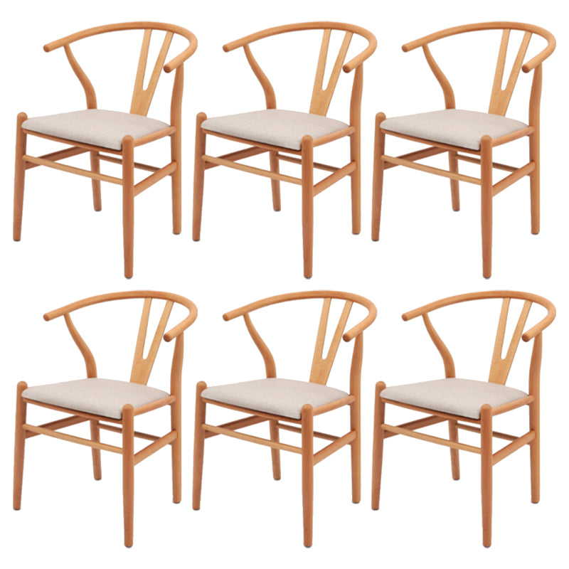 Silla de respaldo moderna de reposabrazos con patas de madera para el comedor