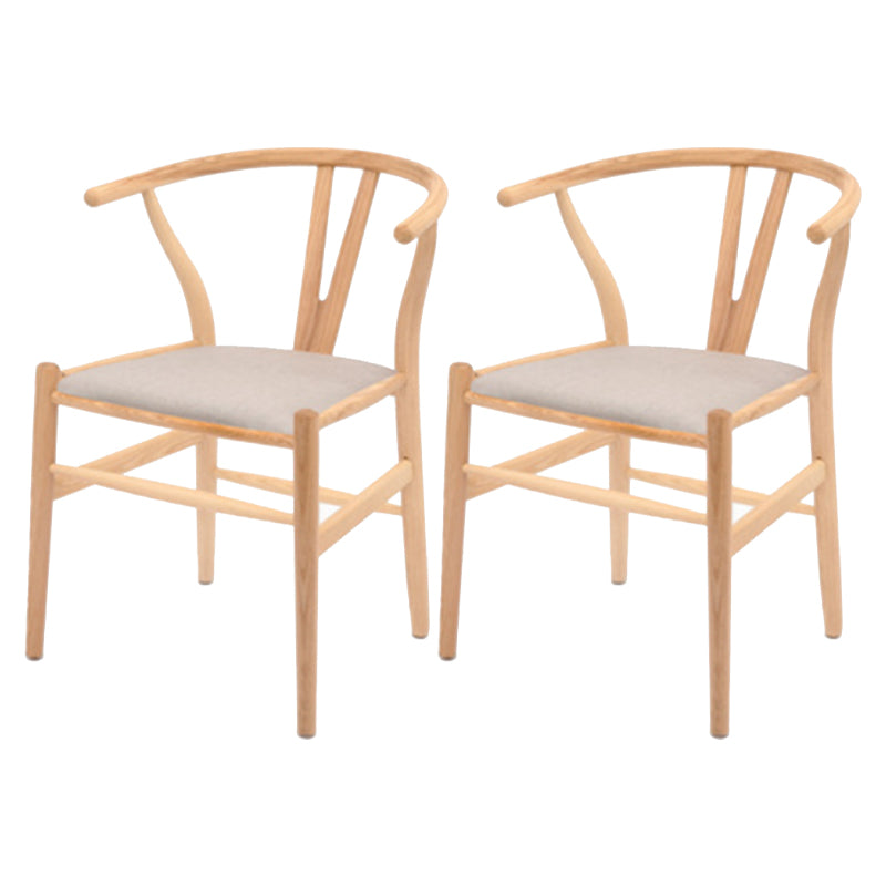 Silla de respaldo moderna de reposabrazos con patas de madera para el comedor