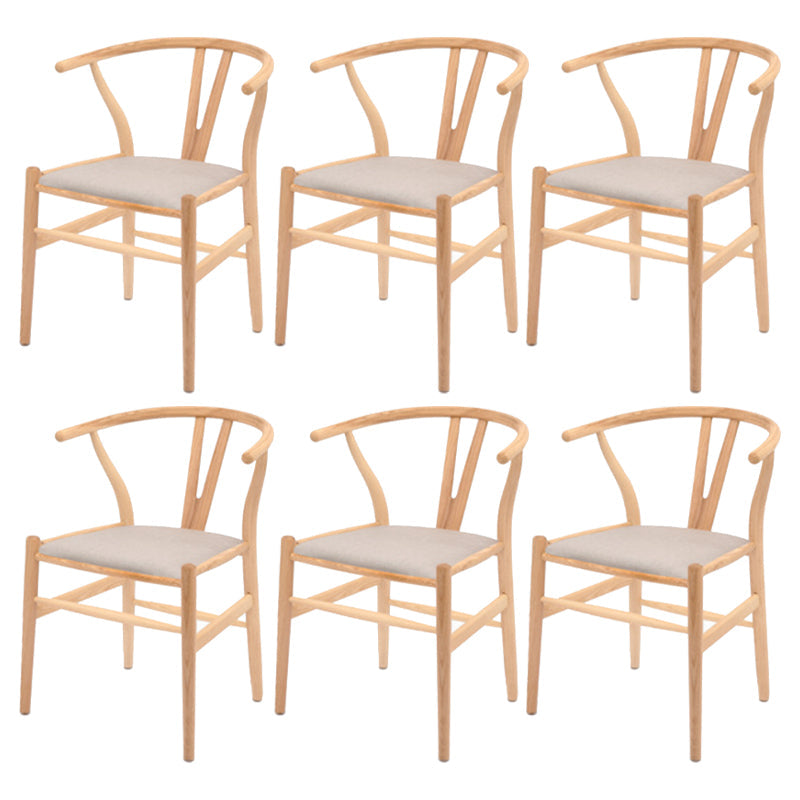 Silla de respaldo moderna de reposabrazos con patas de madera para el comedor