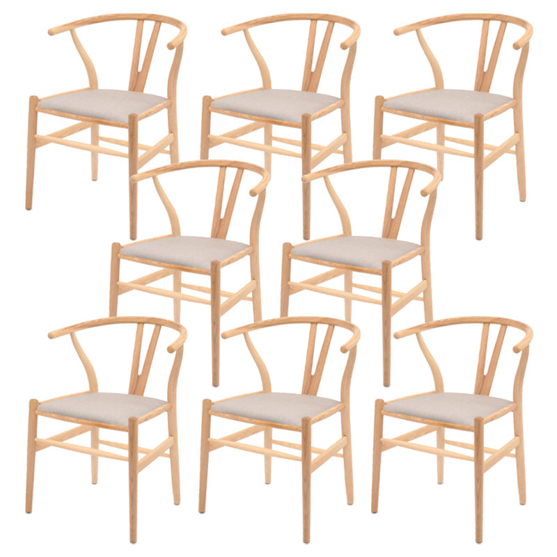 Silla de respaldo moderna de reposabrazos con patas de madera para el comedor