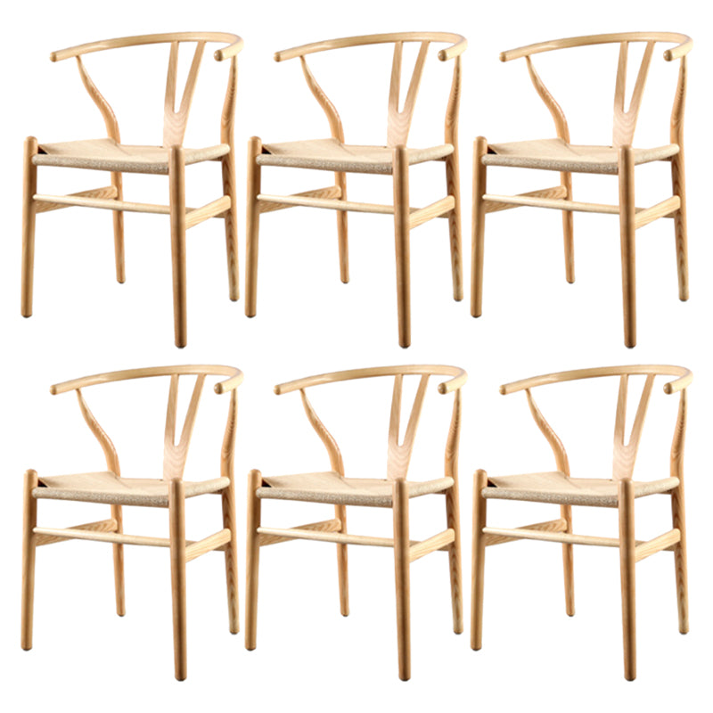 Silla de respaldo moderna de reposabrazos con patas de madera para el comedor