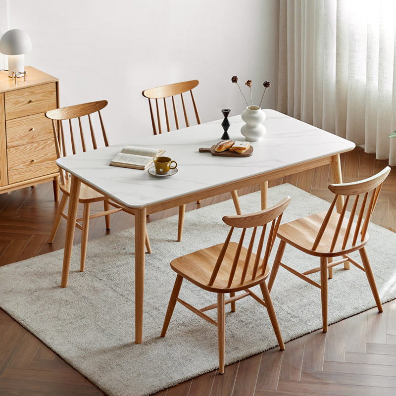 Moderne massief houten poten eettafel met rechthoekig stenen blad