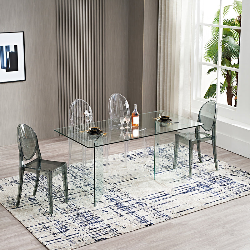 Moderne rechthoekige eettafel met glazen blad en dubbel voetstuk