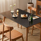 Table de salle à manger rectangulaire moderne avec plateau en pierre noire et 4 pieds en bois massif