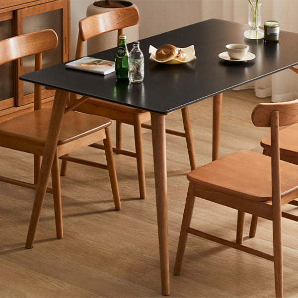 Table de salle à manger rectangulaire moderne avec plateau en pierre noire et 4 pieds en bois massif
