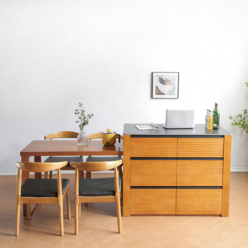Mesa de cocina moderna de piedra negra con base de madera sólida y cajones
