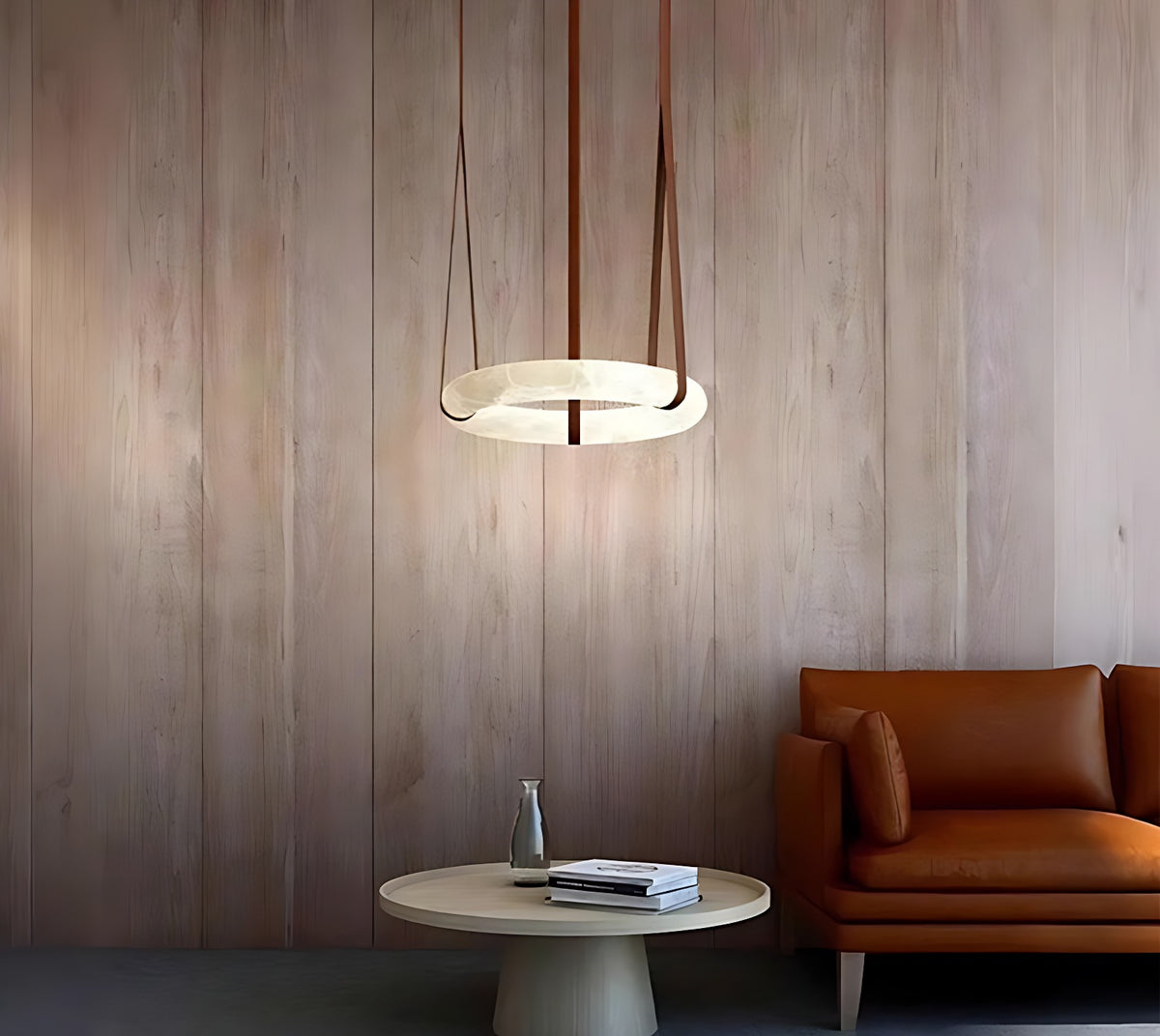 Alabaster Ring Chandelier on Leather Straps with Brass Canopy – ring chandelier over coffee table beside leather sofa, wood-panel wall