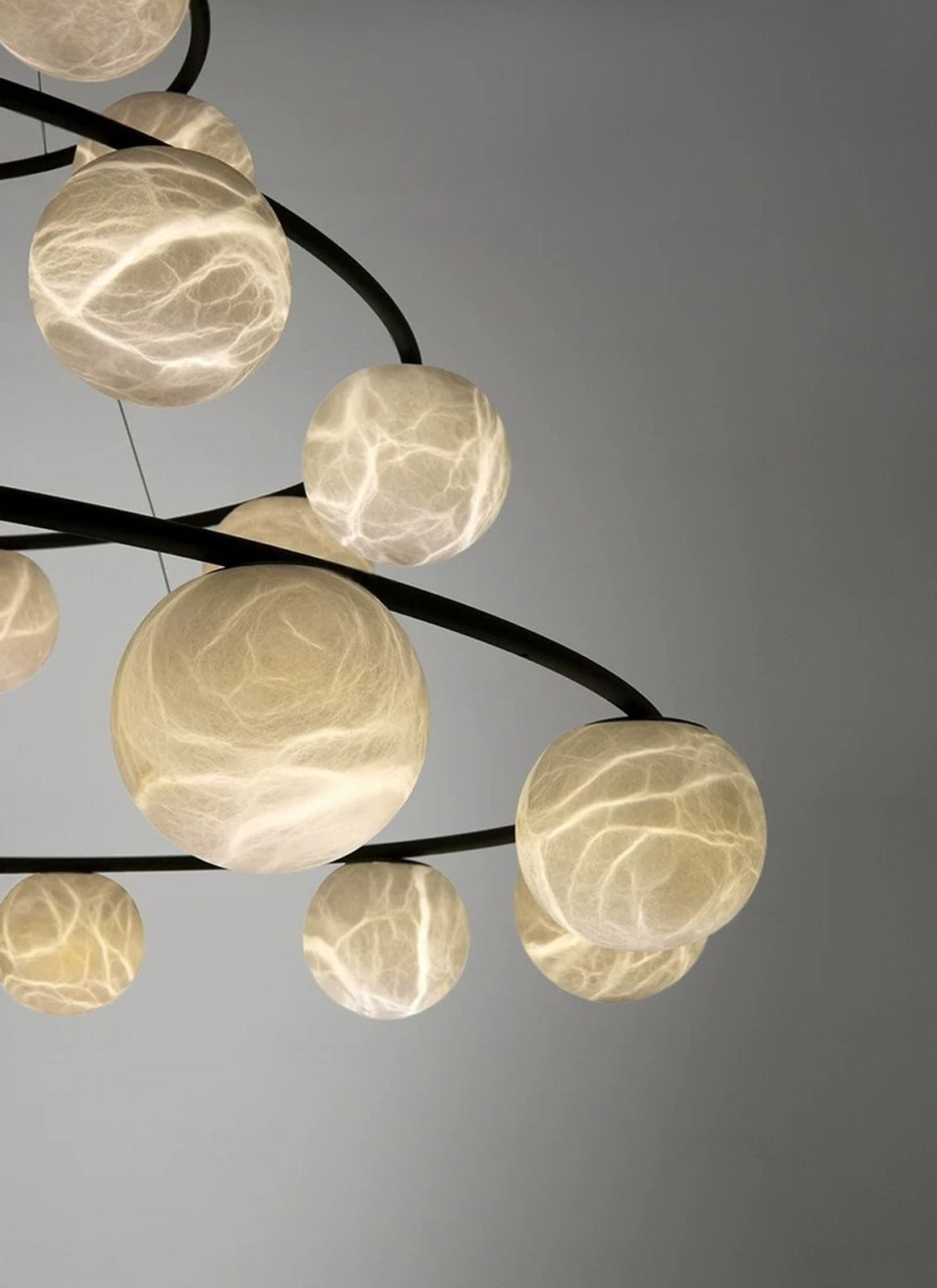 Black Ring Chandelier with Alabaster Globes, 6 to 12 Heads or 3-Tier – lit globes on black rings, bright vein pattern glowing through the stone