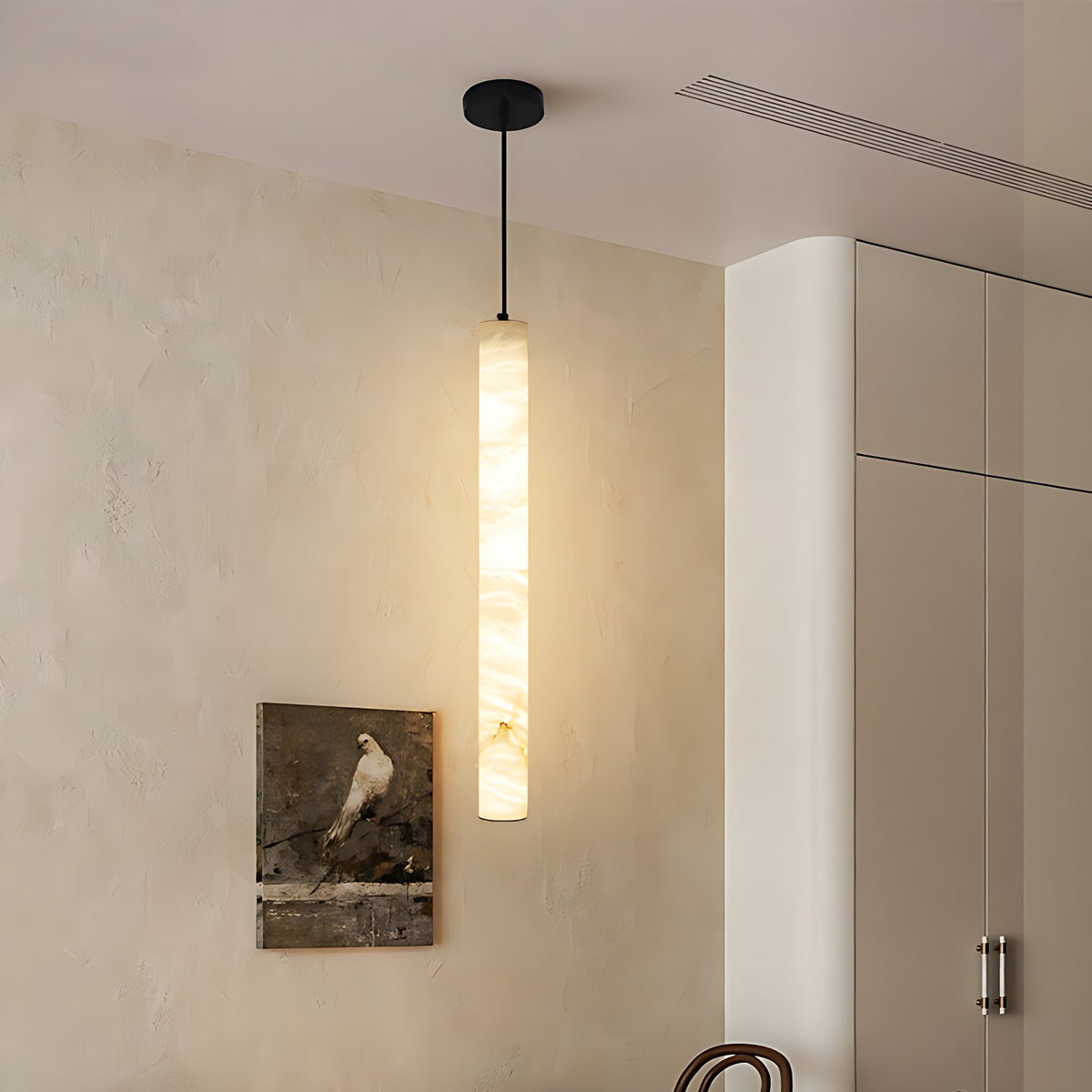 Slim Alabaster Tube Pendant Light with Copper Canopy, Adjustable Cord – black-canopy tube pendant lit against plaster wall in a hallway