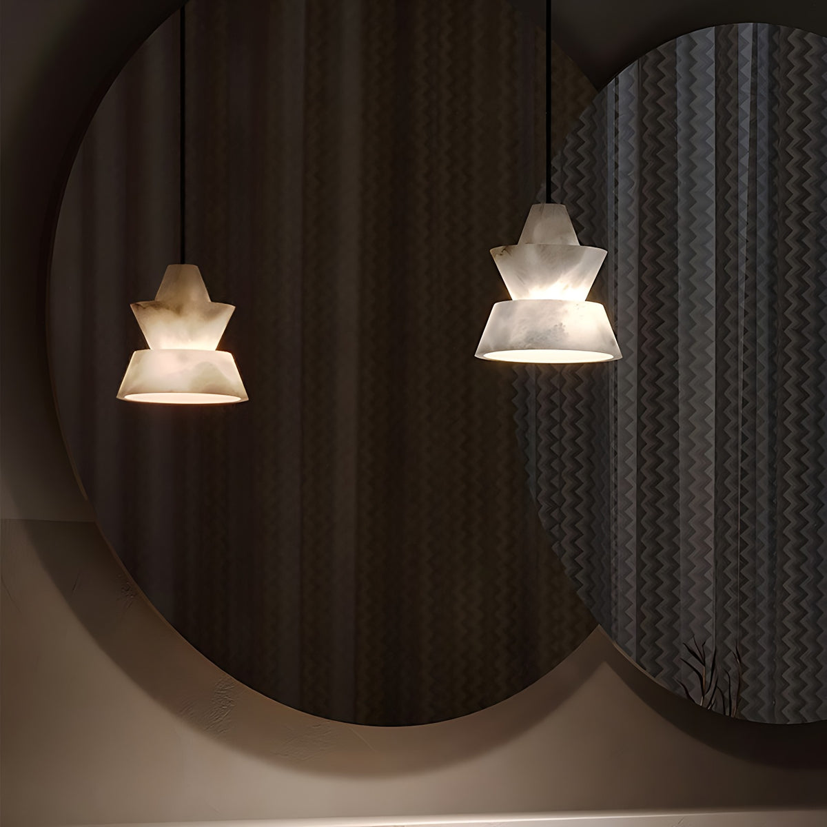 Faceted Alabaster Bell Pendant Light, Natural Spanish Stone, 3 Shapes – two lit bell pendants glowing against a dark round mirror