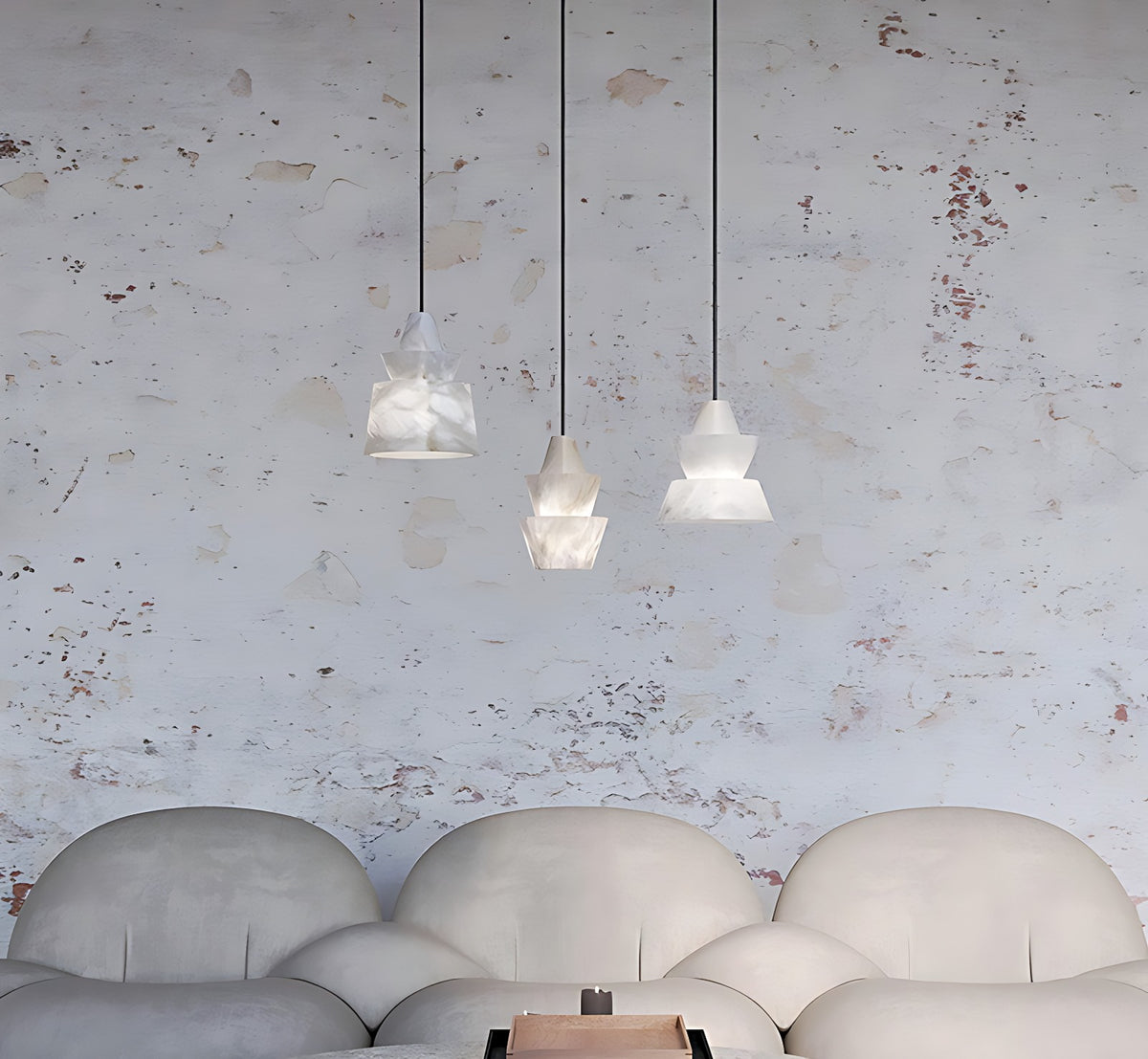 Faceted Alabaster Bell Pendant Light, Natural Spanish Stone, 3 Shapes – all three shapes hung together over a sofa, unlit