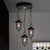 Caged Clear Glass Multi Pendant Vintage 3-Light Living Room Hanging Light Fixture in Black with Round Canopy Black Clearhalo 'Ceiling Lights' 'Glass shade' 'Glass' 'Industrial Pendants' 'Industrial' 'Middle Century Pendants' 'Pendant Lights' 'Pendants' 'Tiffany' Lighting' 141078