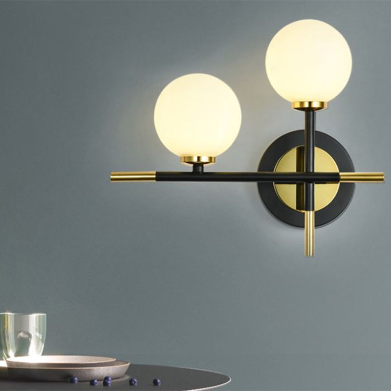 Milk Glass Orb Sconce Light with Cross Design 2 Lights Modern Black and Brass Wall Light Clearhalo 'Cast Iron' 'Glass' 'Industrial' 'Modern wall lights' 'Modern' 'Tiffany' 'Traditional wall lights' 'Vanity Lights' 'Wall Lights' Lighting' 1433707