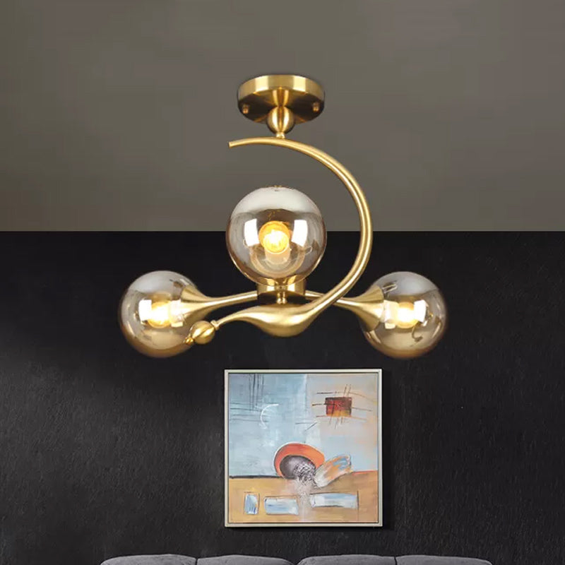 Burst Semi Flush Chandelier Postmodern Amber Glass Orb 3/5 Heads Brass Ceiling Mounted Light with Curved Arm over Table