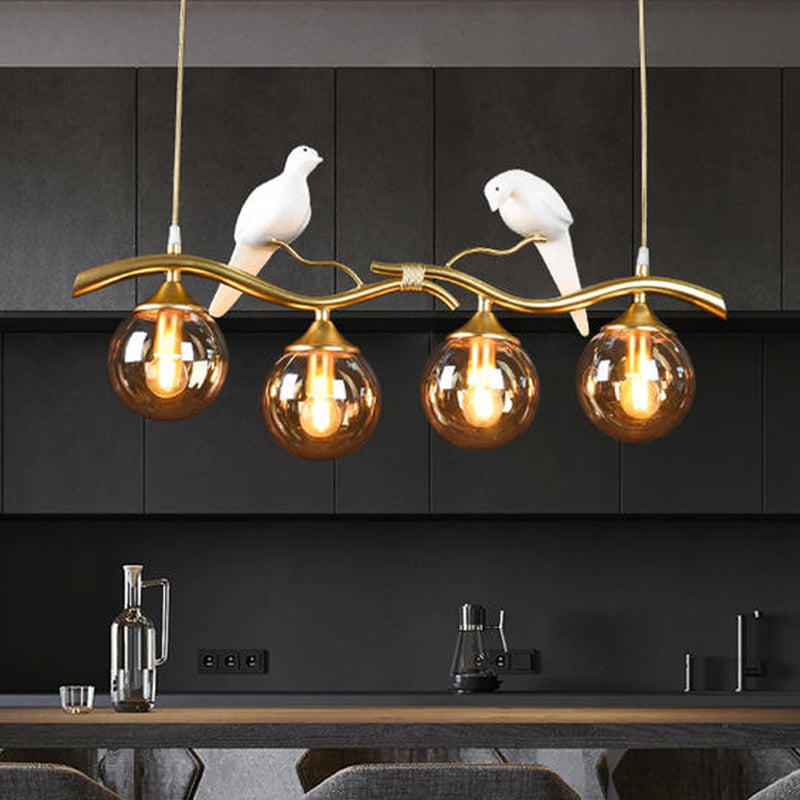Sprig Island Pendant Light Postmodern Iron 4-Light Black/Gold Hanging Lamp with Amber Ball Glass Shade and Bird Deco Gold Clearhalo 'Ceiling Lights' 'Glass shade' 'Glass' 'Island Lights' Lighting' 1456063