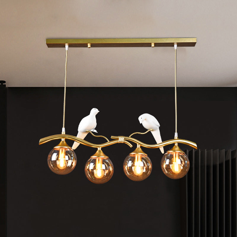 Sprig Island Pendant Light Postmodern Iron 4-Light Black/Gold Hanging Lamp with Amber Ball Glass Shade and Bird Deco Clearhalo 'Ceiling Lights' 'Glass shade' 'Glass' 'Island Lights' Lighting' 1456064