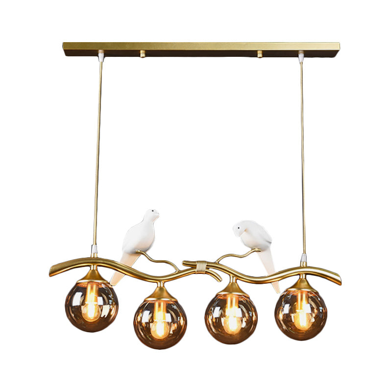 Sprig Island Pendant Light Postmodern Iron 4-Light Black/Gold Hanging Lamp with Amber Ball Glass Shade and Bird Deco Clearhalo 'Ceiling Lights' 'Glass shade' 'Glass' 'Island Lights' Lighting' 1456066