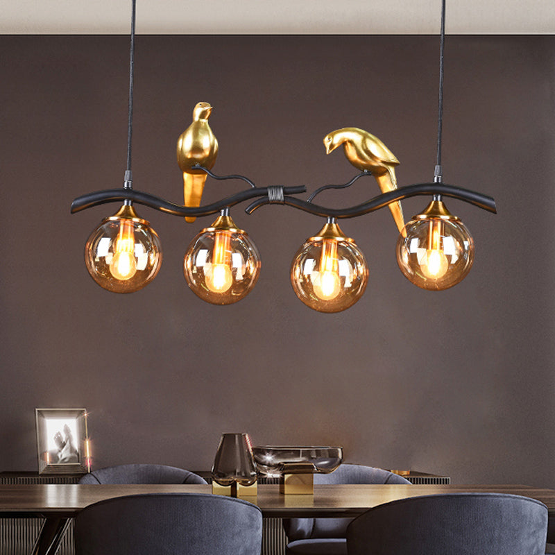 Sprig Island Pendant Light Postmodern Iron 4-Light Black/Gold Hanging Lamp with Amber Ball Glass Shade and Bird Deco Clearhalo 'Ceiling Lights' 'Glass shade' 'Glass' 'Island Lights' Lighting' 1456069