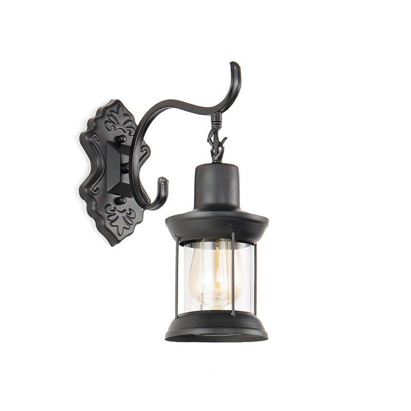 Lantern Clear Glass Wall Mounted Lamp Vintage Single Bulb Outdoor Sconce Light in Black with Carved Pattern Clearhalo 'Art deco wall lights' 'Cast Iron' 'Glass' 'Industrial wall lights' 'Industrial' 'Middle century wall lights' 'Modern' 'Rustic wall lights' 'Tiffany' 'Traditional wall lights' 'Wall Lamps & Sconces' 'Wall Lights' Lighting' 146919