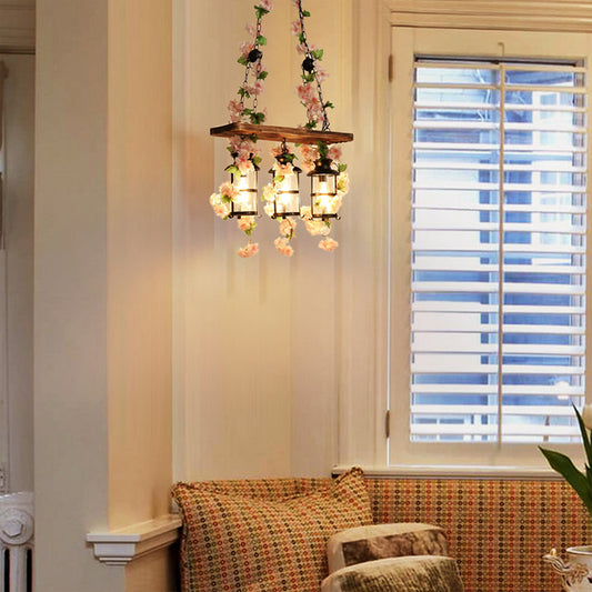 Rustic Lantern Island Lamp with Artificial Flower and Wood Board 3 Lights Pendant Light Black Clearhalo 'Ceiling Lights' 'Close To Ceiling Lights' 'Glass shade' 'Glass' 'Island Lights' Lighting' 162389