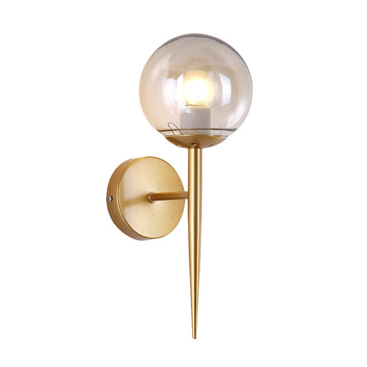 Clear Glass Globe Wall Sconce Modern 1 Light Living Room Lighting Fixture in Gold Clearhalo 'Cast Iron' 'Glass' 'Industrial wall lights' 'Industrial' 'Middle century wall lights' 'Modern' 'Tiffany' 'Traditional wall lights' 'Wall Lamps & Sconces' 'Wall Lights' Lighting' 164743
