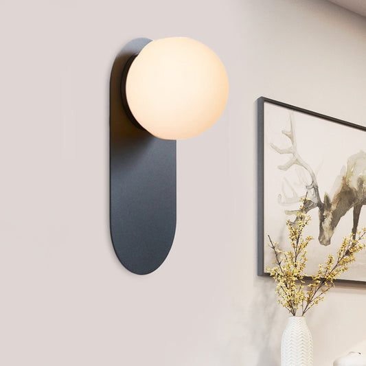 Iron Elliptical Flush Mount Minimalist 1 Bulb Black Wall Sconce Light with Orb Glass Shade Black Clearhalo 'Cast Iron' 'Glass' 'Industrial' 'Modern wall lights' 'Modern' 'Tiffany' 'Traditional wall lights' 'Wall Lamps & Sconces' 'Wall Lights' Lighting' 1788529