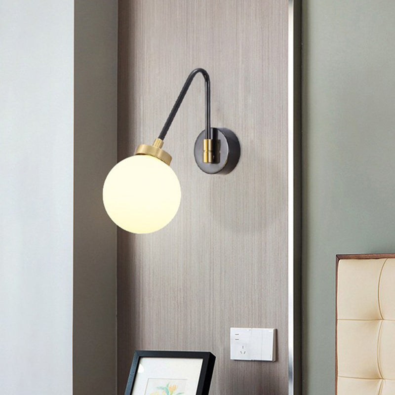 Minimalism Orb White Glass Wall Light 1 Head Sconce Light Fixture with Black-Gold Angled Arm Clearhalo 'Cast Iron' 'Glass' 'Industrial' 'Modern wall lights' 'Modern' 'Tiffany' 'Traditional wall lights' 'Wall Lamps & Sconces' 'Wall Lights' Lighting' 1788543