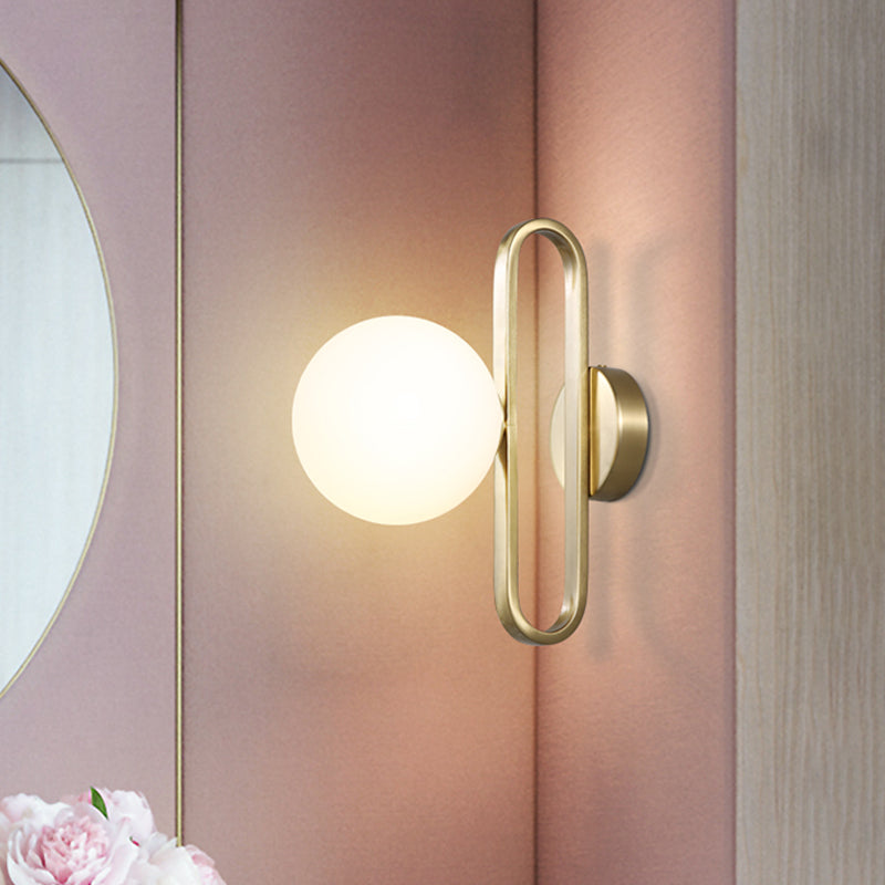 Cream Matte Glass Orb Wall Light Minimalist 1 Bulb Sconce Lighting with Gold Oval Arm Clearhalo 'Cast Iron' 'Glass' 'Industrial' 'Modern wall lights' 'Modern' 'Tiffany' 'Traditional wall lights' 'Wall Lamps & Sconces' 'Wall Lights' Lighting' 1788567