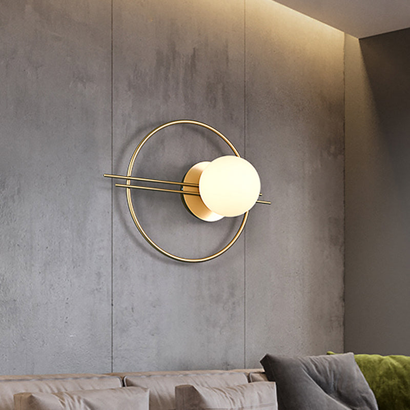 Circle Lounge Sconce Light Iron 1 Head Postmodern Wall Mounted Lighting in Black/Brass with Ball White Glass Shade Brass Clearhalo 'Cast Iron' 'Glass' 'Industrial' 'Modern wall lights' 'Modern' 'Tiffany' 'Traditional wall lights' 'Wall Lamps & Sconces' 'Wall Lights' Lighting' 1788572