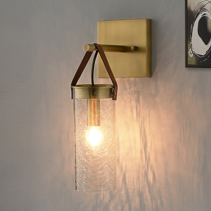 Postmodern Cylindrical Sconce Ideas Clear Crack Glass 1 Head Dining Room Wall Mounted Lamp in Brass with Leather Strap Clearhalo 'Cast Iron' 'Glass' 'Industrial' 'Modern wall lights' 'Modern' 'Tiffany' 'Traditional wall lights' 'Wall Lamps & Sconces' 'Wall Lights' Lighting' 1788609