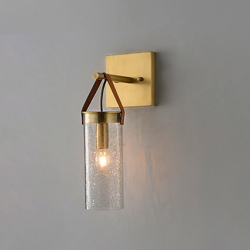 Postmodern Cylindrical Sconce Ideas Clear Crack Glass 1 Head Dining Room Wall Mounted Lamp in Brass with Leather Strap Clearhalo 'Cast Iron' 'Glass' 'Industrial' 'Modern wall lights' 'Modern' 'Tiffany' 'Traditional wall lights' 'Wall Lamps & Sconces' 'Wall Lights' Lighting' 1788612