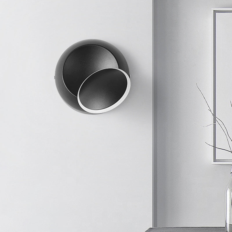 Black/White Rotating Ellipse Wall Lamp Modern Novelty Iron LED Surface Wall Sconce with Simulated Eclipse Design Clearhalo 'Cast Iron' 'Glass' 'Industrial' 'Modern wall lights' 'Modern' 'Tiffany' 'Traditional wall lights' 'Wall Lamps & Sconces' 'Wall Lights' Lighting' 1788982