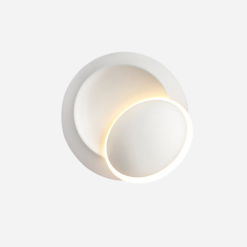 Black/White Rotating Ellipse Wall Lamp Modern Novelty Iron LED Surface Wall Sconce with Simulated Eclipse Design Clearhalo 'Cast Iron' 'Glass' 'Industrial' 'Modern wall lights' 'Modern' 'Tiffany' 'Traditional wall lights' 'Wall Lamps & Sconces' 'Wall Lights' Lighting' 1788990