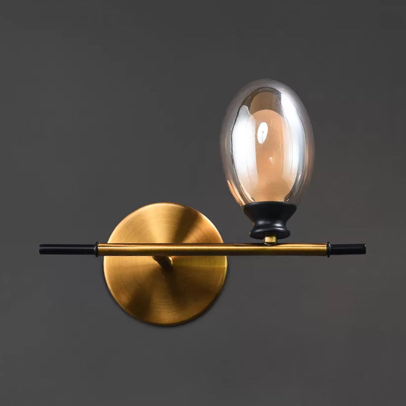 Brass Straight Rod Wall Lamp Mid Century 1 Head Metal Sconce Ideas with Dual Oval Clear/Amber Glass Shade Clearhalo 'Cast Iron' 'Glass' 'Industrial' 'Modern wall lights' 'Modern' 'Tiffany' 'Traditional wall lights' 'Wall Lamps & Sconces' 'Wall Lights' Lighting' 1789121