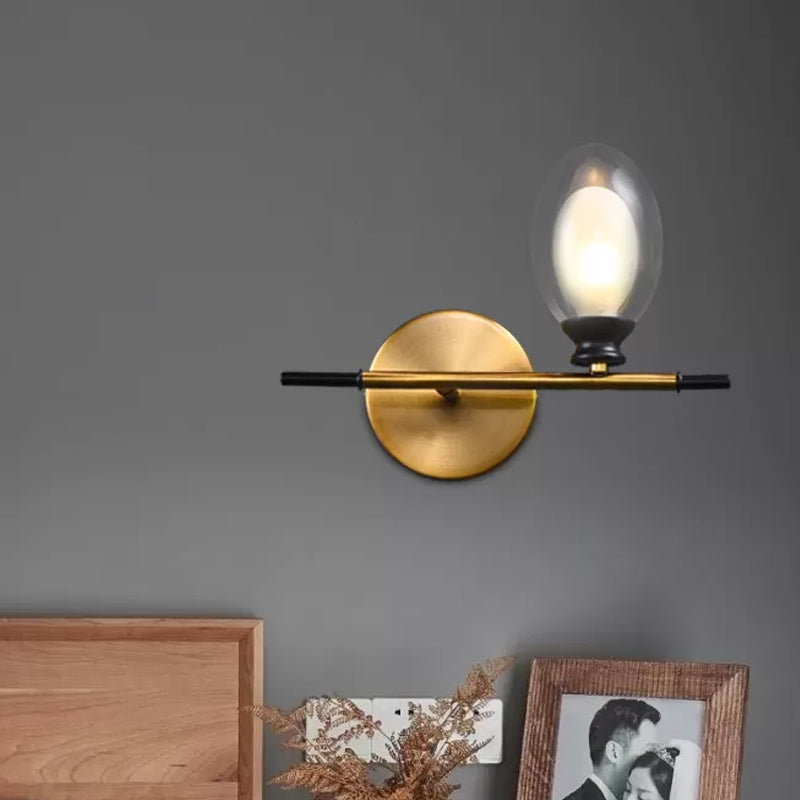 Brass Straight Rod Wall Lamp Mid Century 1 Head Metal Sconce Ideas with Dual Oval Clear/Amber Glass Shade Clearhalo 'Cast Iron' 'Glass' 'Industrial' 'Modern wall lights' 'Modern' 'Tiffany' 'Traditional wall lights' 'Wall Lamps & Sconces' 'Wall Lights' Lighting' 1789124