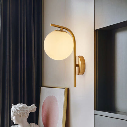 Postmodern Ball Wall Mount Light Grey/Clear Water/White Glass Single-Bulb Bedside Wall Lamp with Bent Arm in Brass White Clearhalo 'Cast Iron' 'Glass' 'Industrial' 'Modern wall lights' 'Modern' 'Tiffany' 'Traditional wall lights' 'Wall Lamps & Sconces' 'Wall Lights' Lighting' 1936619