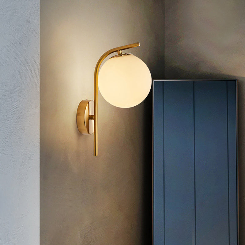 Postmodern Ball Wall Mount Light Grey/Clear Water/White Glass Single-Bulb Bedside Wall Lamp with Bent Arm in Brass Clearhalo 'Cast Iron' 'Glass' 'Industrial' 'Modern wall lights' 'Modern' 'Tiffany' 'Traditional wall lights' 'Wall Lamps & Sconces' 'Wall Lights' Lighting' 1936620