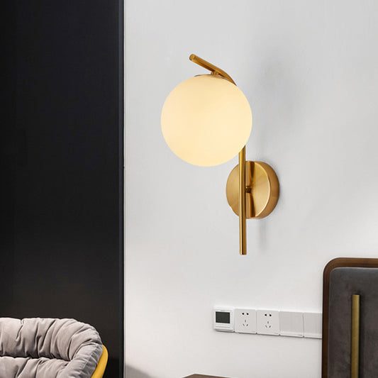 Postmodern Ball Wall Mount Light Grey/Clear Water/White Glass Single-Bulb Bedside Wall Lamp with Bent Arm in Brass Clearhalo 'Cast Iron' 'Glass' 'Industrial' 'Modern wall lights' 'Modern' 'Tiffany' 'Traditional wall lights' 'Wall Lamps & Sconces' 'Wall Lights' Lighting' 1936621