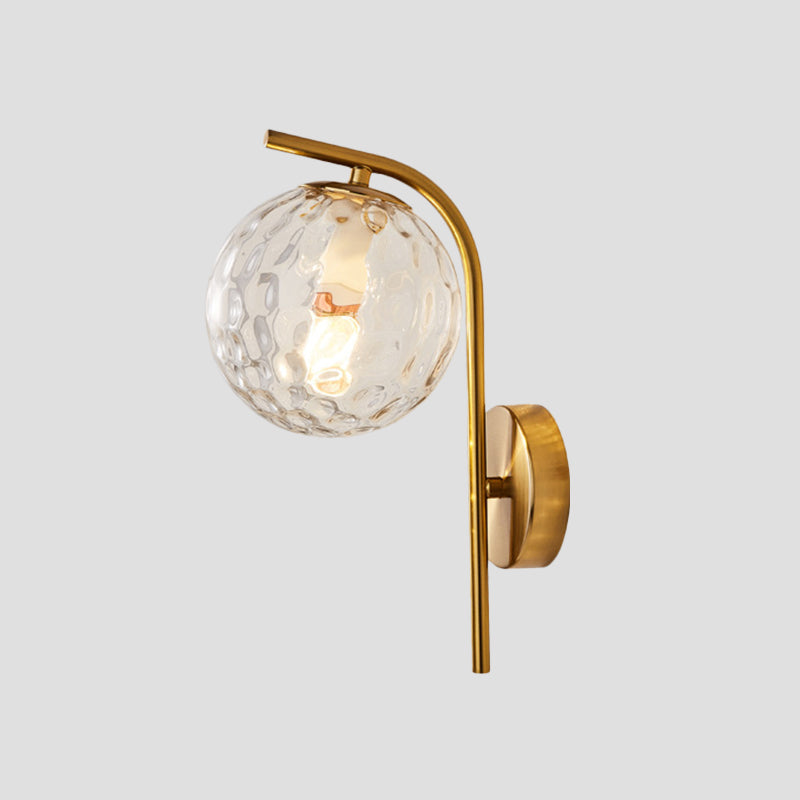 Postmodern Ball Wall Mount Light Grey/Clear Water/White Glass Single-Bulb Bedside Wall Lamp with Bent Arm in Brass Clearhalo 'Cast Iron' 'Glass' 'Industrial' 'Modern wall lights' 'Modern' 'Tiffany' 'Traditional wall lights' 'Wall Lamps & Sconces' 'Wall Lights' Lighting' 1936625